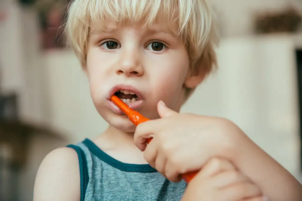 portrait of little boy brushing his teeth with an 2022 03 08 01 25 04 utc 1 2