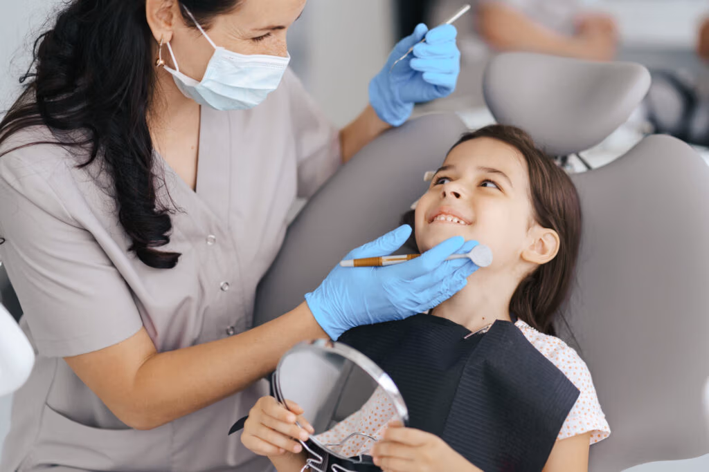 Little girl smiling at the dentist during a filling appointment