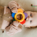 Baby playing with colorful teething toy