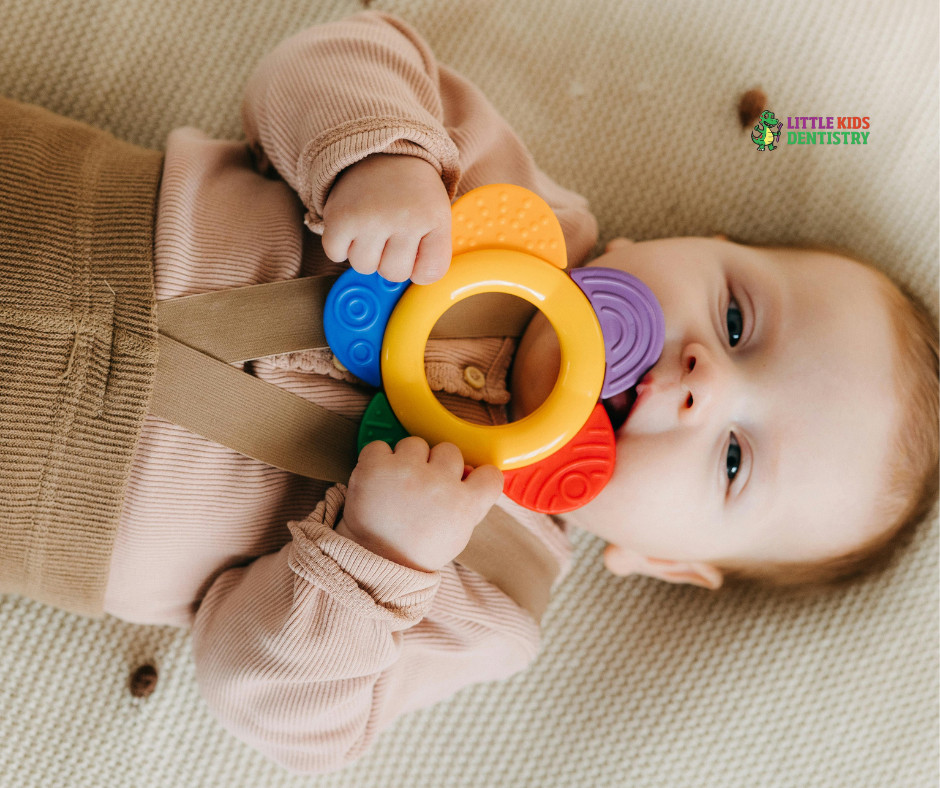Baby playing with colorful teething toy