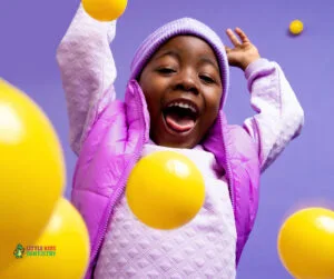 Niño jugando feliz con pelotas