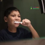 Child brushing teeth in bathroom