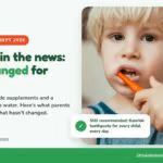A young boy brushing his teeth, with the headline Fluoride in the news: what changed for kids
